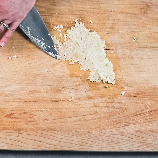 making garlic paste with salt