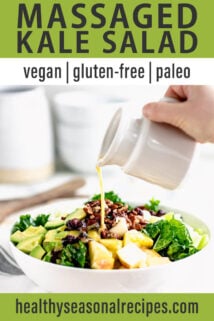 a white bowl with kale salad, a pitcher of dressing is being poured over it