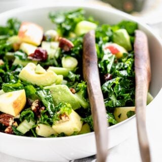 A bowl of tossed kale salad