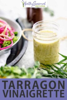 a jar of dressing on a table with salads