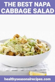 Napa Caesar in a white bowl with salad tongs