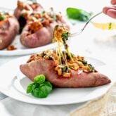 a stuffed sweet potato from the side with a forkful being lifted out
