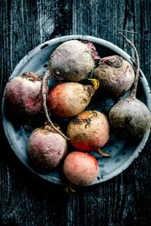 a large bowl of multicolored beets, including gold, red and purple