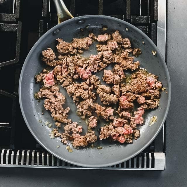 brown the chicken (or turkey) with shallot, salt and oregano in a non-stick skillet