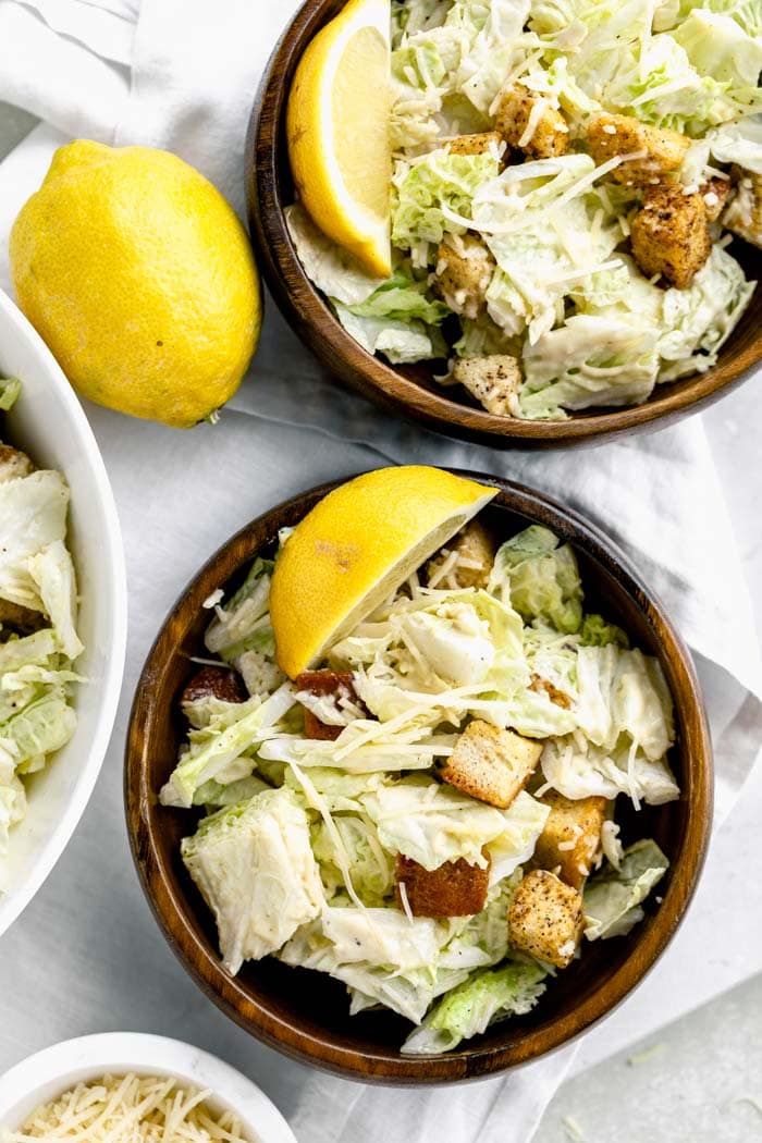 wooden bowls with servings of Caesar in it