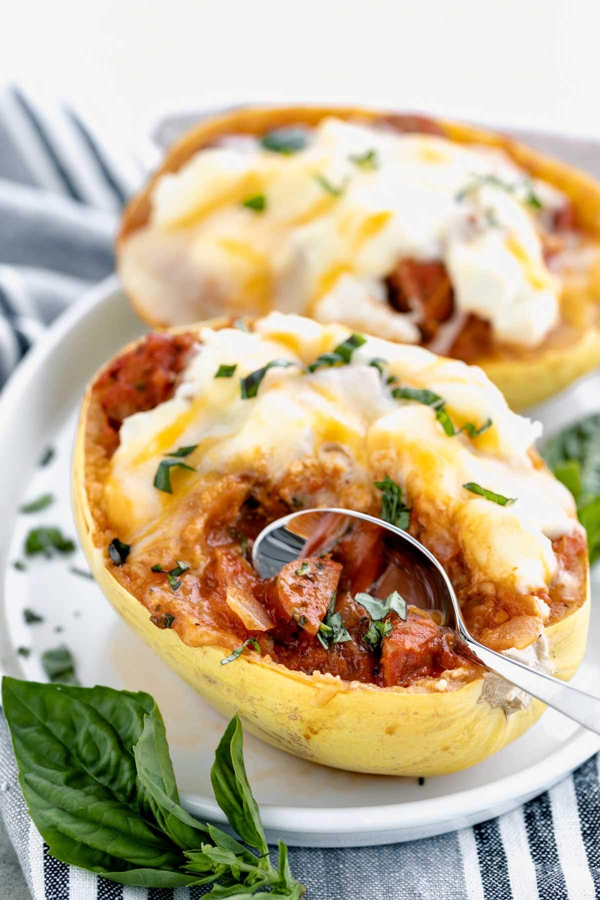 side view of the stuffed spaghetti squash with a scoop removed