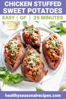 a platter with four stuffed sweet potatoes on it and a glass of wine