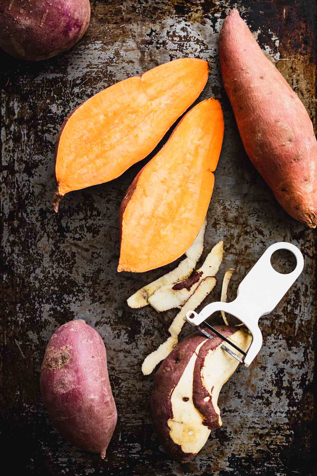halved orange sweet potato and a peeled white sweet potato.