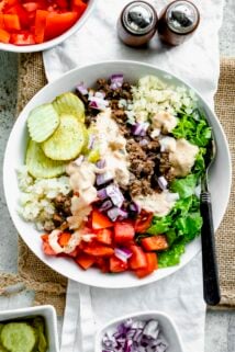 burger bowl in a white low pasta bowl with a fork