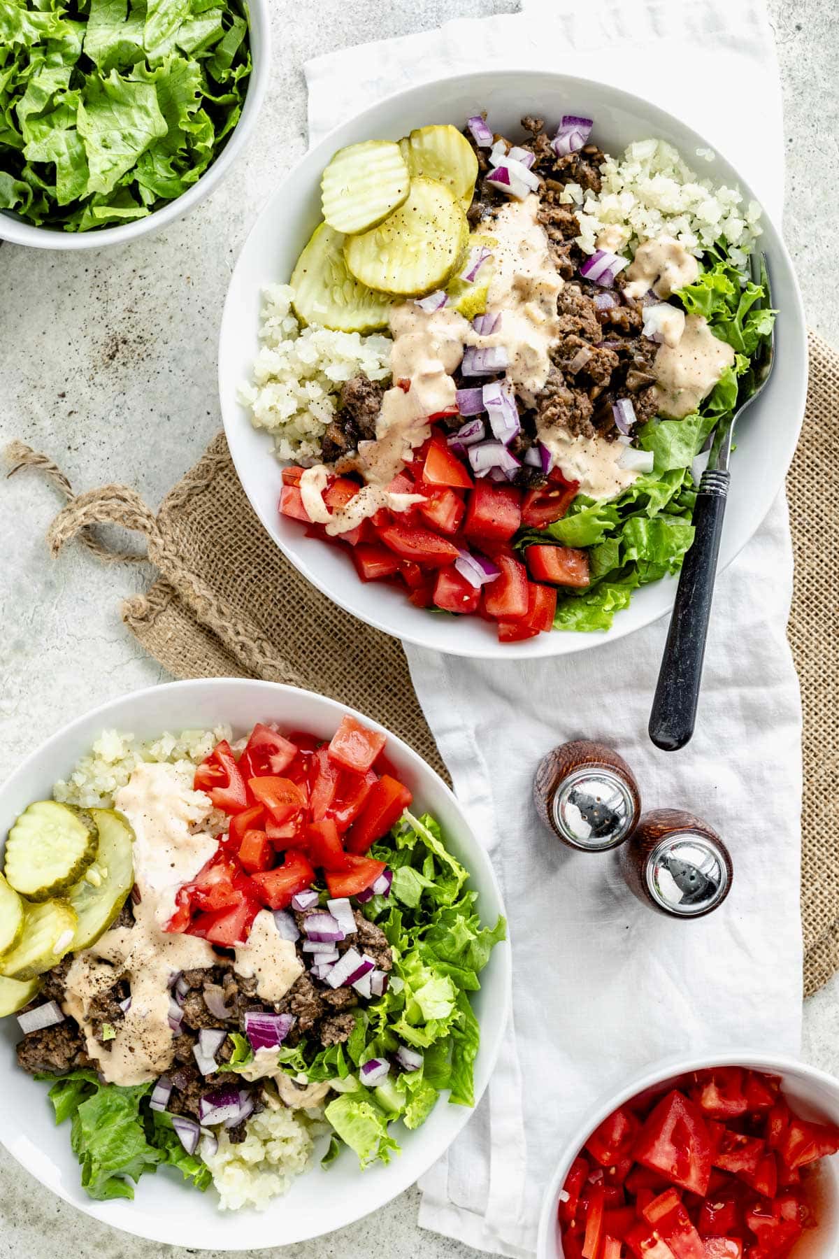 two burger bowls on a table side by side