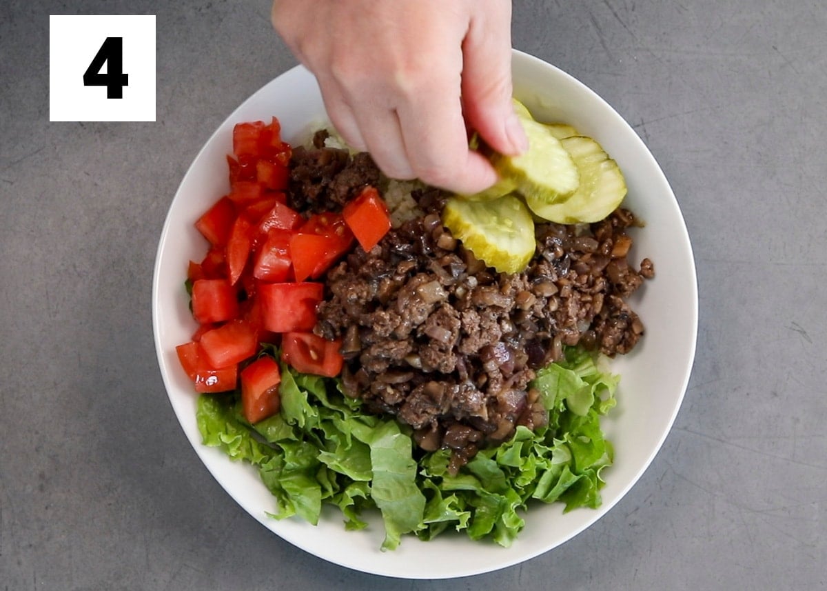 adding a pickle to the burger bowl