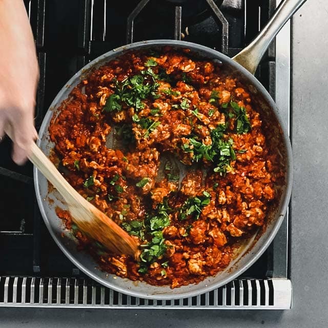 the skillet with the filling and the cilantro on top