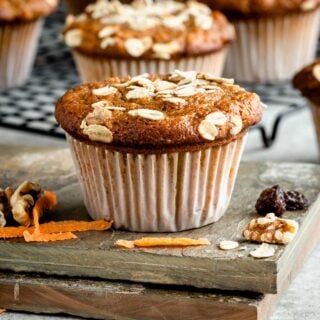 side view of muffin with pieces of carrot and nuts around it
