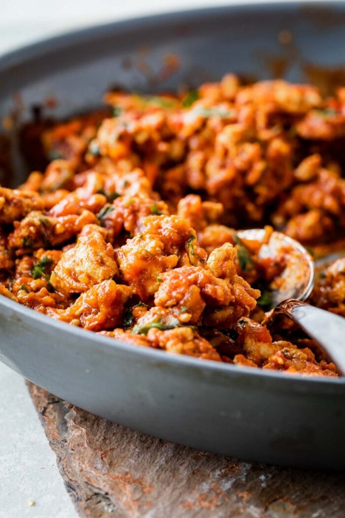 seasoned and cooked chicken meat in the skillet for the sandwiches