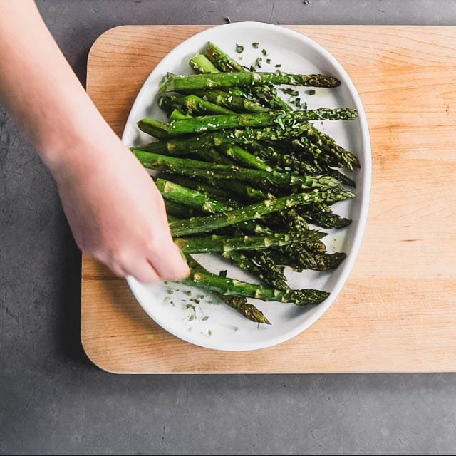 plattering the asparagus with garnishes