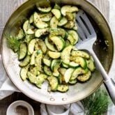 a skillet with sauteed zucchini in it