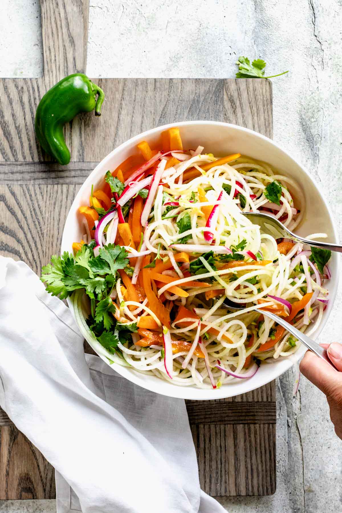 tossing the kohlrabi with the dressing