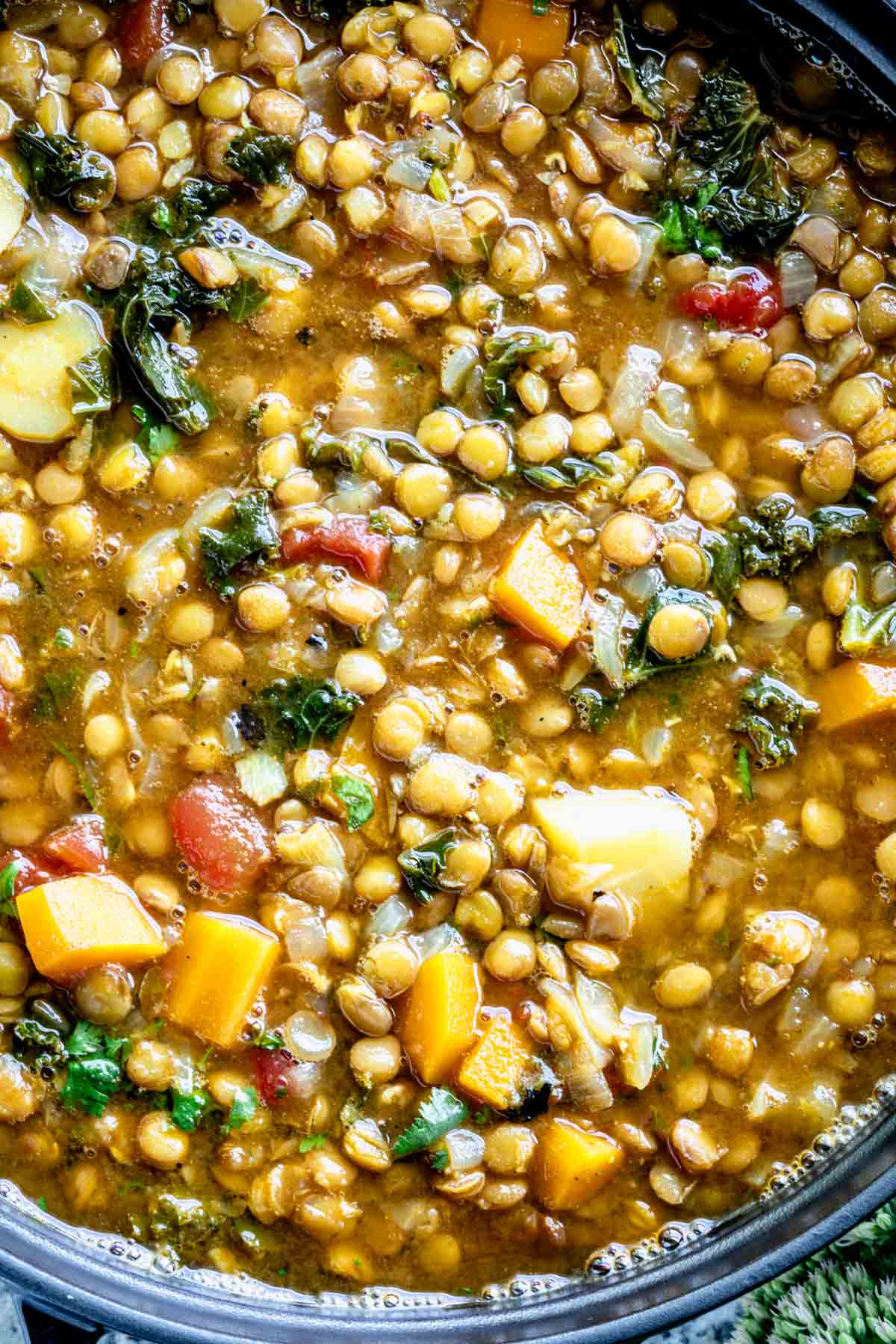 close-up of lentil soup in a black pot