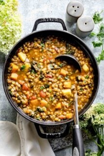 black pot overhead with soup with a ladle