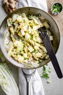 a skillet with the sauteed Napa cabbage in it
