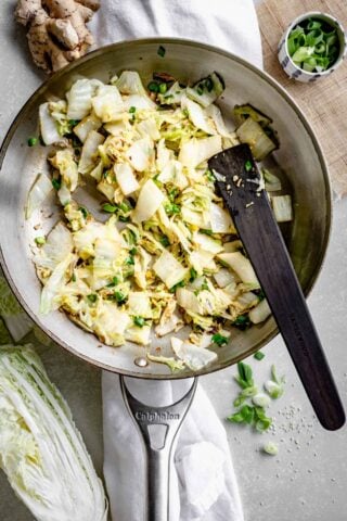 a skillet with the sauteed Napa cabbage in it