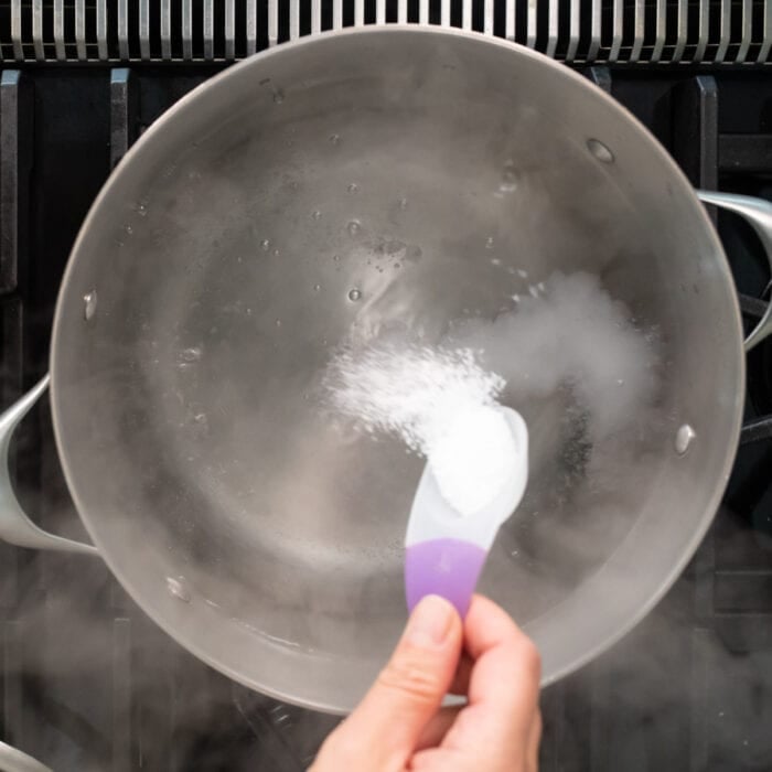adding kosher salt to the boiling water
