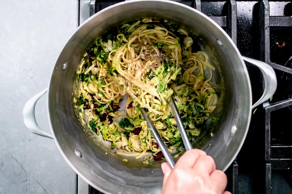 tossin the pasta with the Brussels