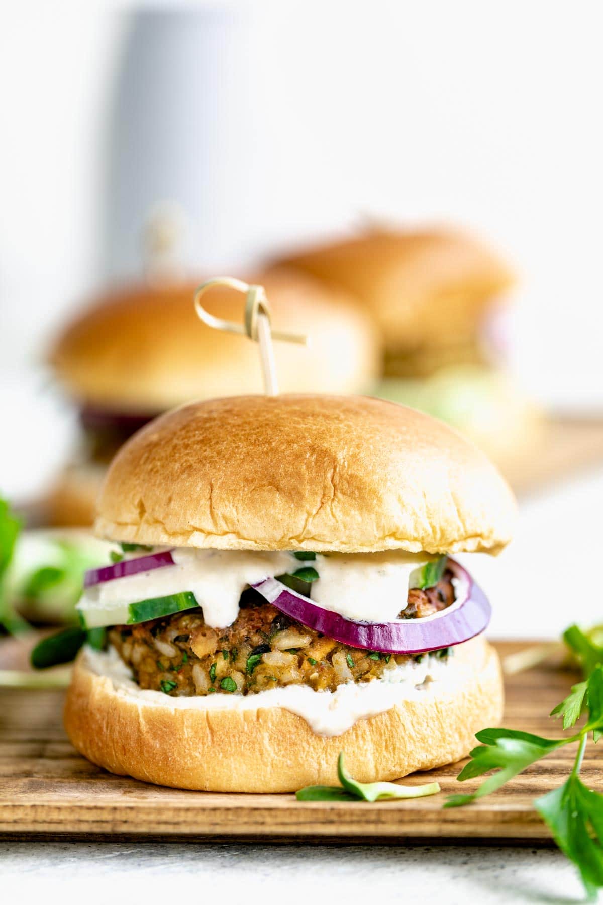 burger on a wooden plate from the side