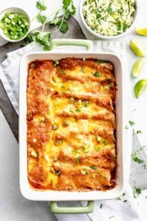 Overhead view of a casserole dish with baked chicken enchiladas