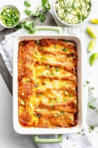 Overhead view of a casserole dish with baked chicken enchiladas