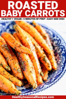 WHOLE BABY CARROTS ROASTED AND MIXED WITH PESTO IN A BLUE BOWL