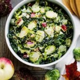 Shaved Brussel sprouts in circular white bowl.