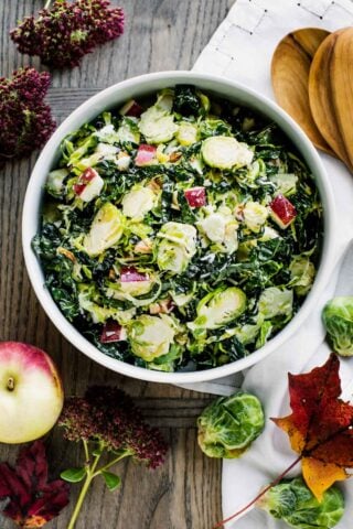 Shaved Brussel sprouts in circular white bowl.