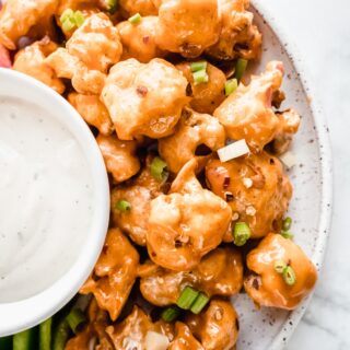 white platter of bang bang cauliflower with dip