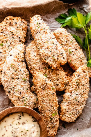 crispy air fryer chicken cutlets in a dish with brown parchment
