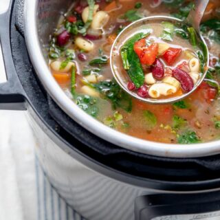 Close up of pressure cooker minestrone soup in a ladle
