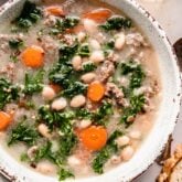 Sausage Kale soup with carrots and white beans in bowl