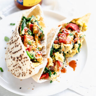 close up of pita bread breakfast on circular white plate