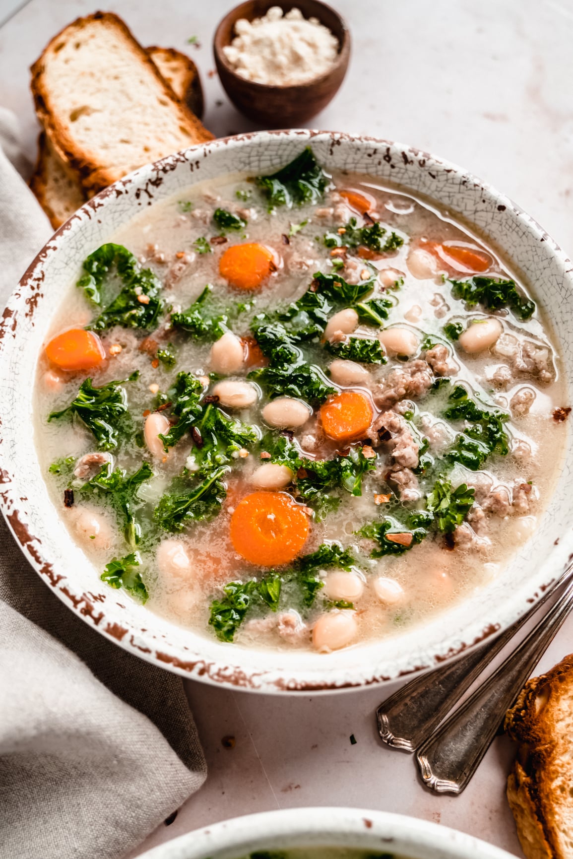 Close up shot of sausage and Kale soup in bowl