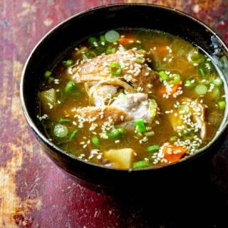 hot pot soup in a black bowl