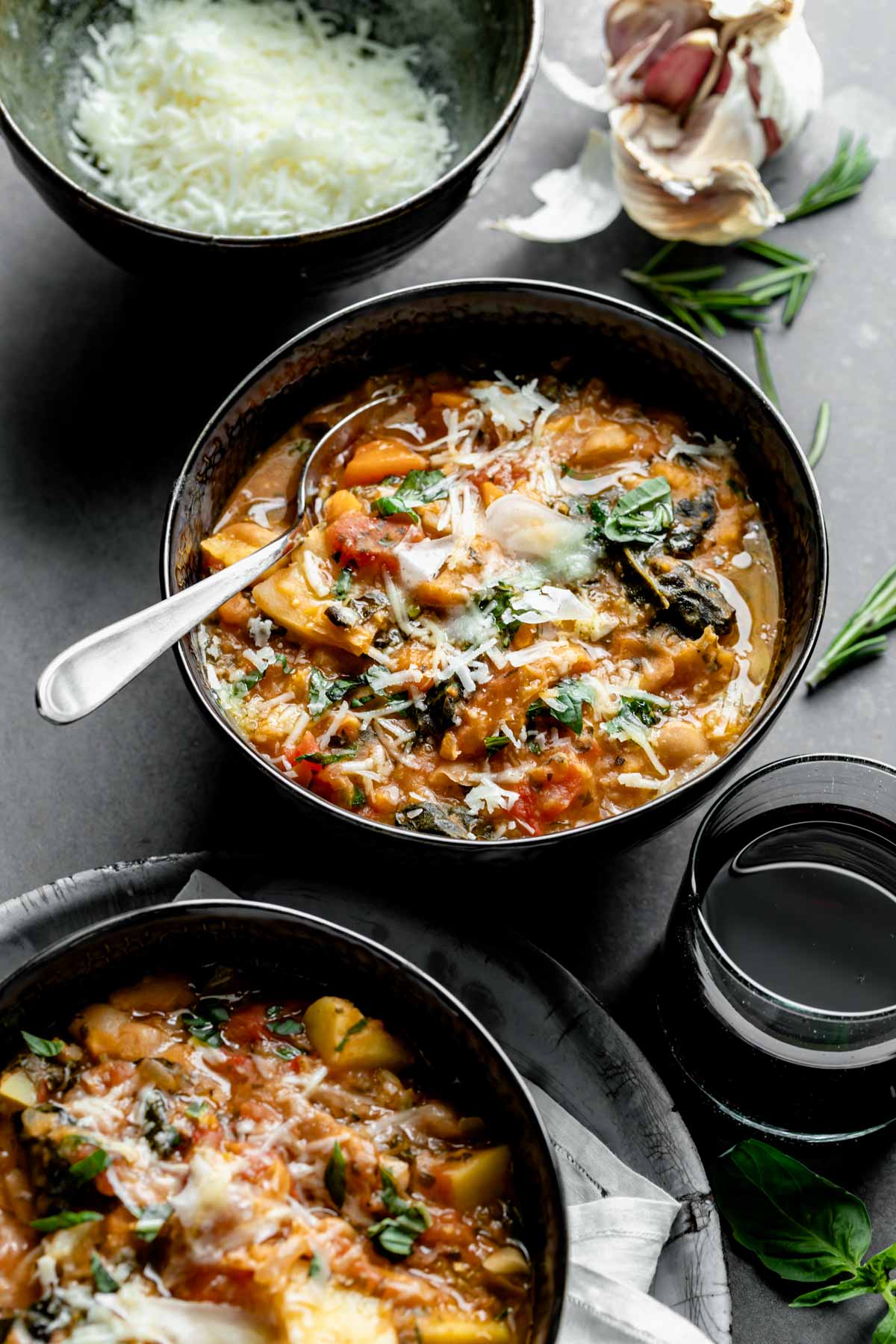 side view angle of two bowls of ribollita. One has a spoon in it