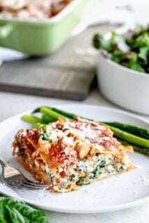 Slice of easy baked vegetable lasagna on a circular white plate.