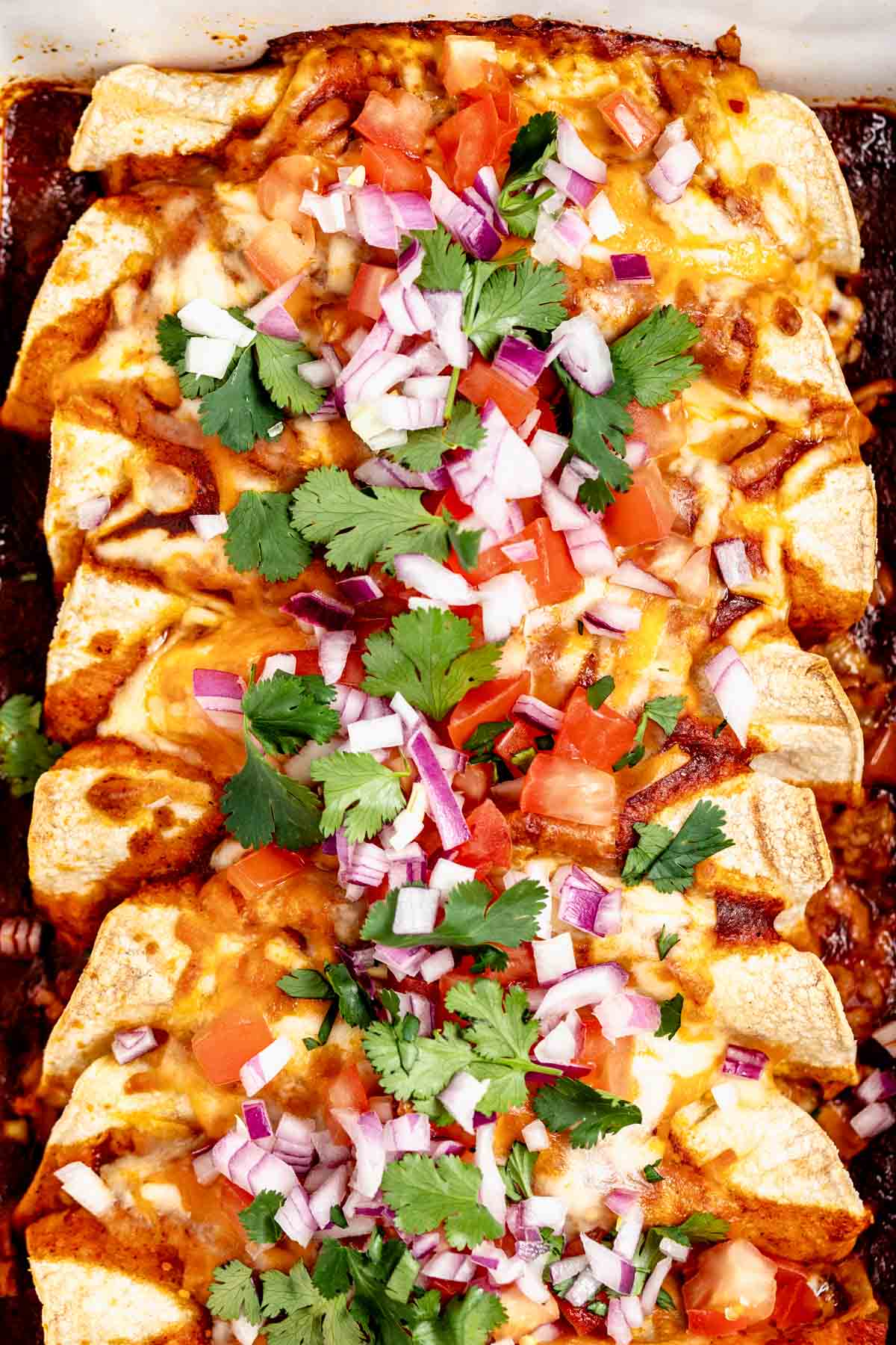 Up close overhead shot of baked easy ground turkey enchiladas.