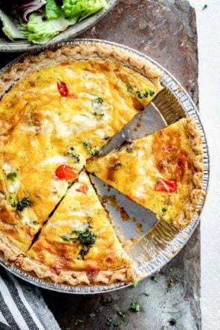 overhead photo of healthy quiche with triangular slices cut into the pie.