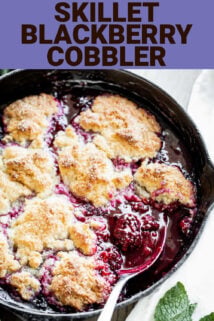 A cast iron with blackberry cobbler in it with a spoon in it. Pin title on the top.