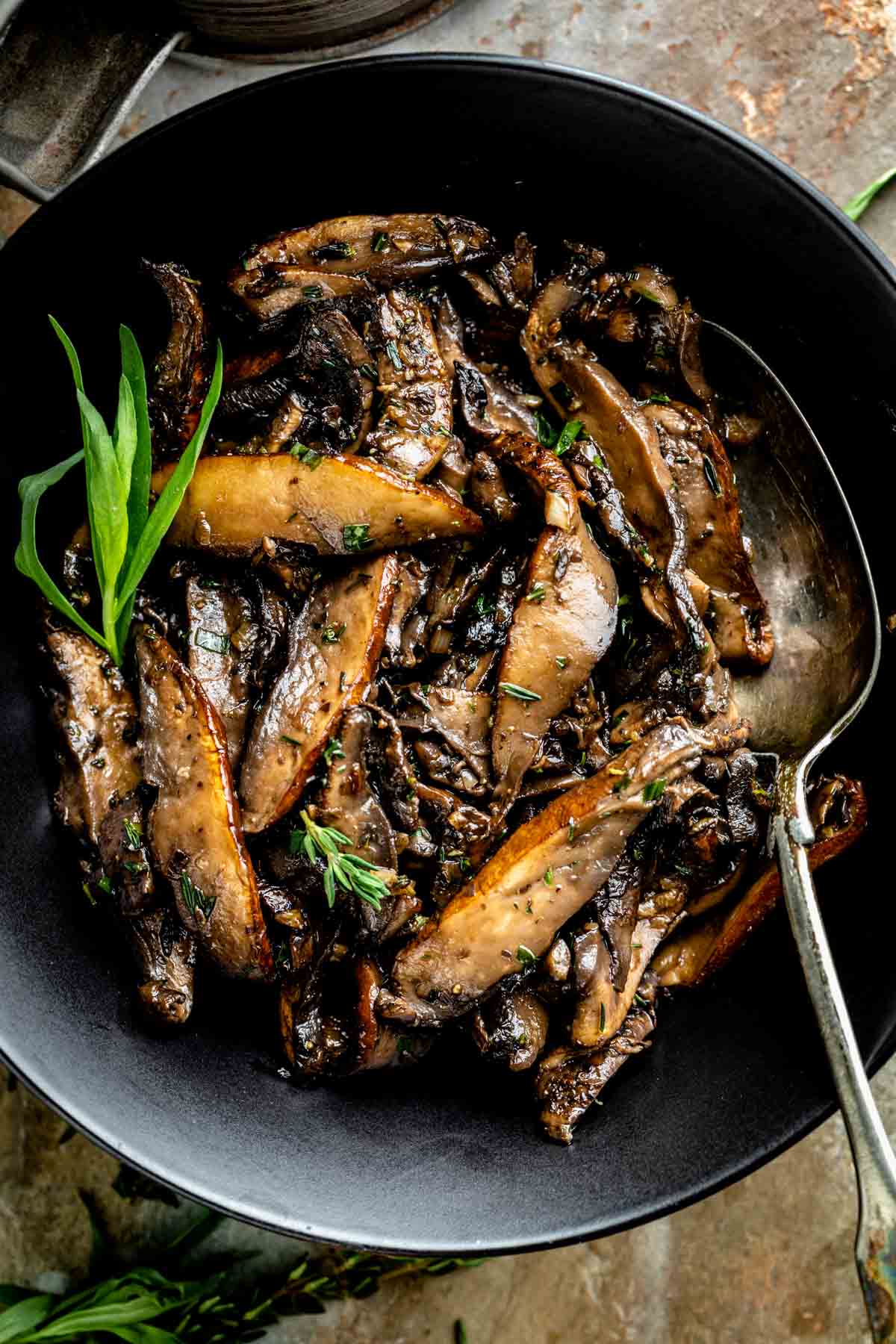 Top view of fried portobello mushrooms in a pan.