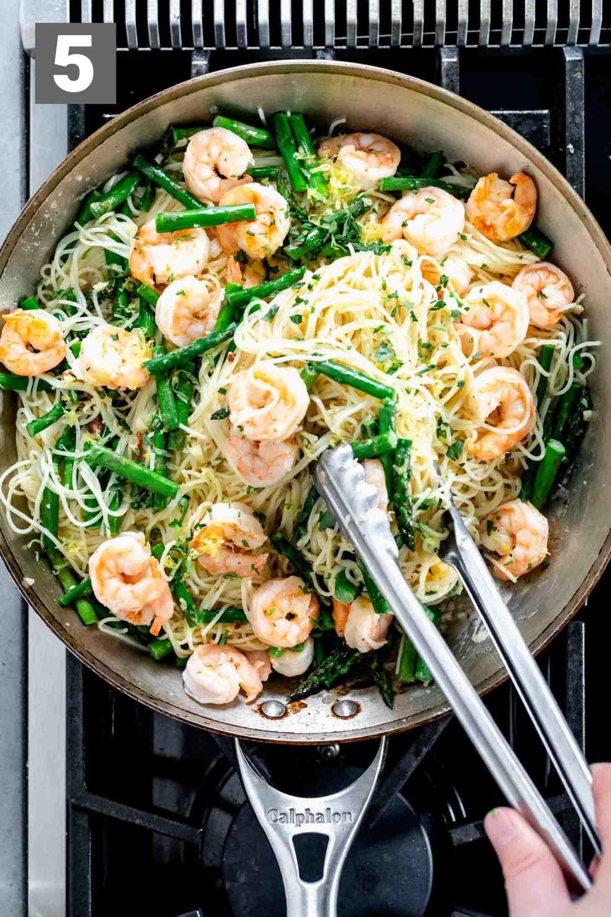 tossing the pasta with the herbs, lemon zest, shrimp and asparagus