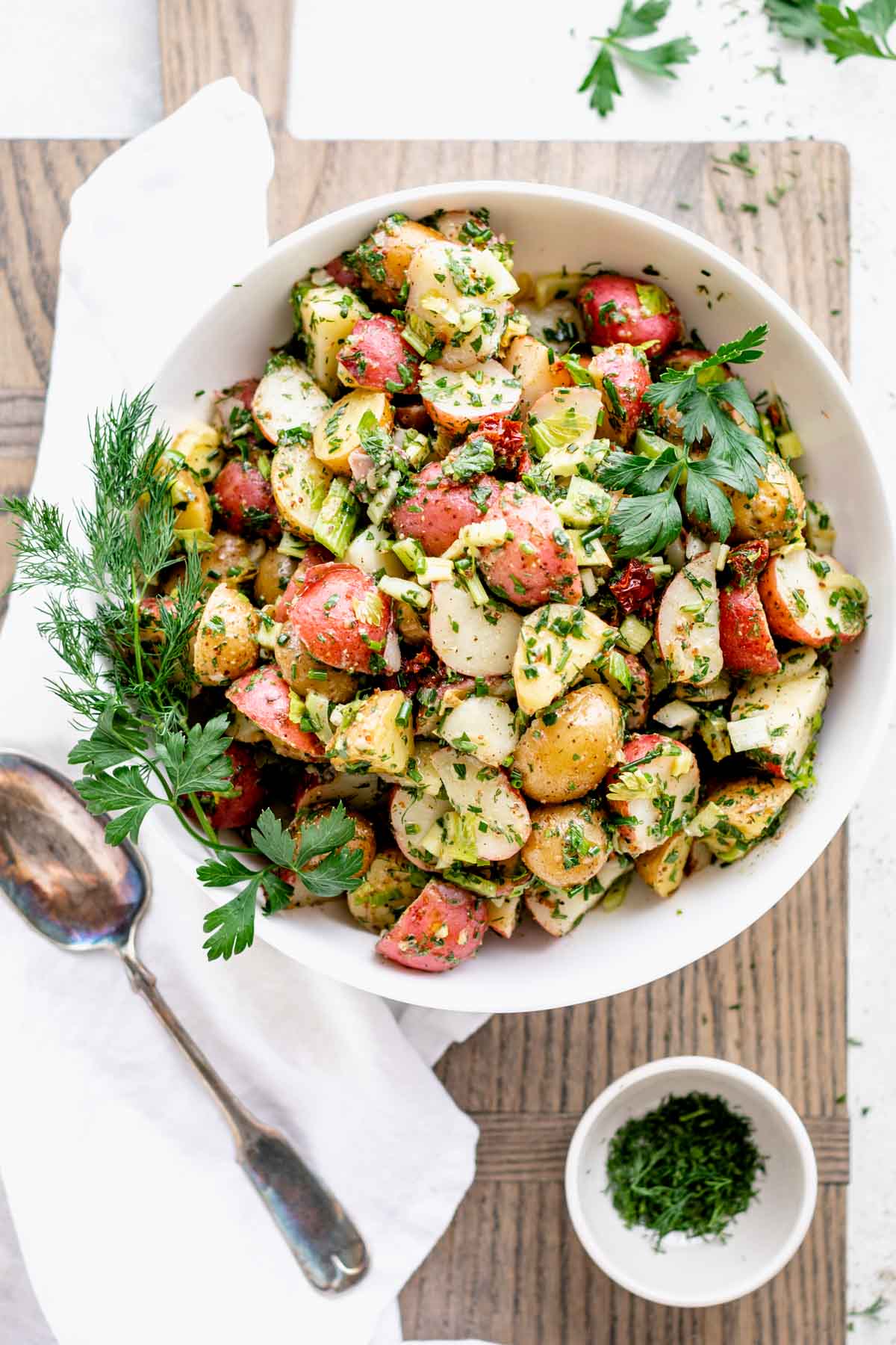 overhead view of the potato salad in a white bowl