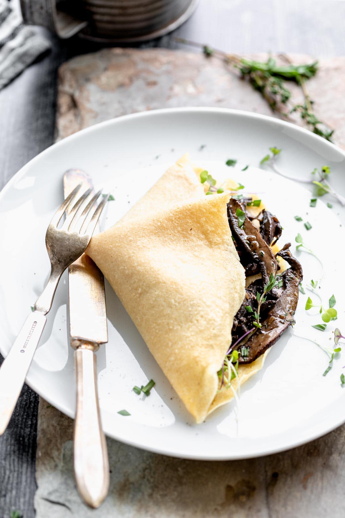 savory mushroom crepe on a white plate