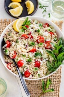 Orzo Pasta salad in a white bowl on a table.